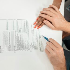 A couple fills out an adoption request form, highlighting commitment and future family planning.